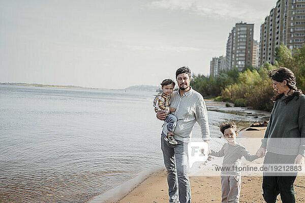 Happy family together walking at beach