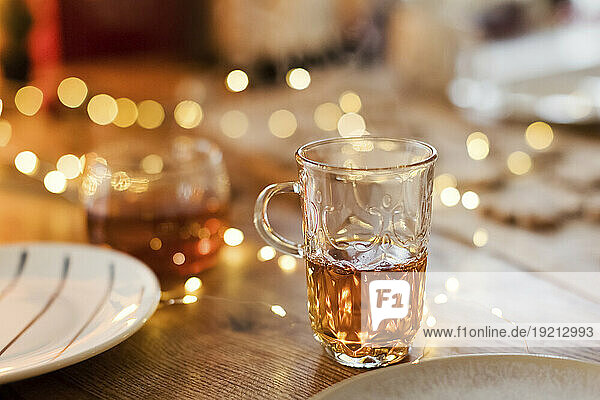 Glass cup of tea on table at home