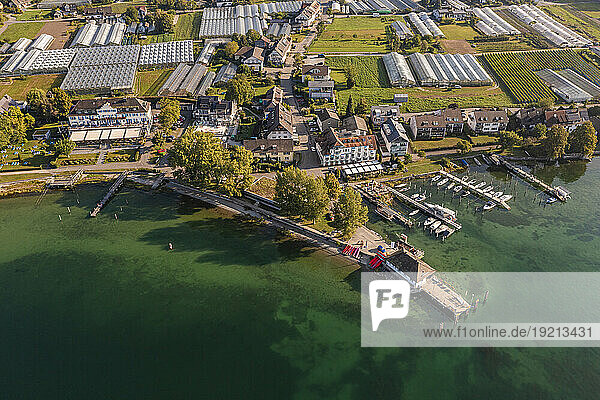 Germany,  Baden-Wurttemberg,  Aerial view of jetties on shore of Reichenau island with greenhouses in background