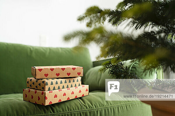 Christmas presents on green sofa at home
