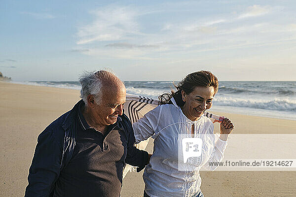 Happy couple walking at beach