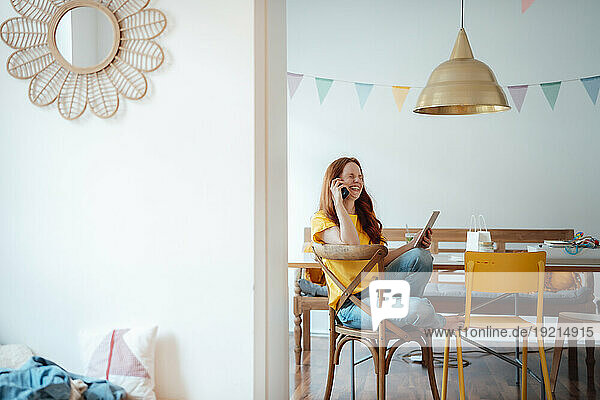 Smiling woman talking on phone at home