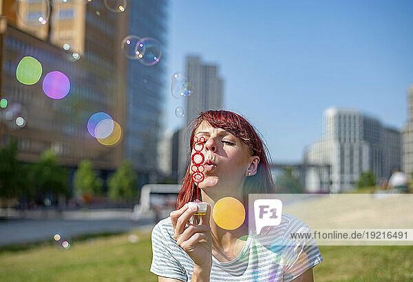 Woman blowing bubbles on sunny day