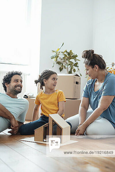 Happy man with daughter talking to mother at home