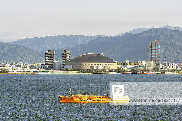 Japan  Fukuoka Prefecture  Fukuoka City  Trawler with PayPay Dome stadium in background