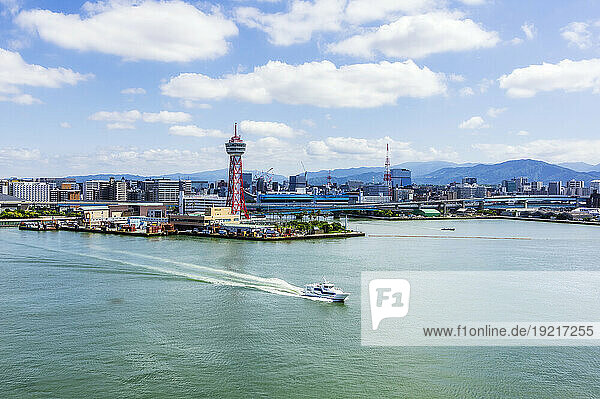 Japan  Fukuoka Prefecture  Fukuoka City  City harbor with motorboat sailing in foreground