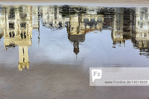 France  Les Sables d'Olonne  85  reflets de facades d'immeubles dans le sable couvert d'eau a maree basse.