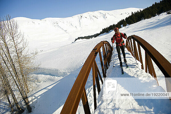 Female Skier Tours The Center Ridge Area In Turnagain Pass Of Chugach National Forest  Alaska