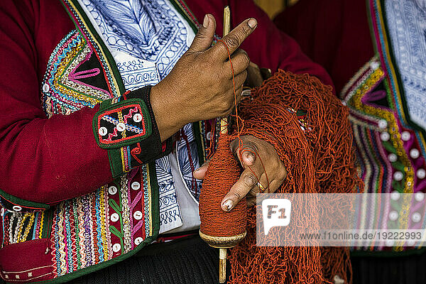 Quechuan women of Chinchero weave traditional clothes in traditional ways for sale; Cusco  Peru