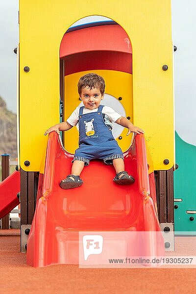 Baby spielt auf einem Spielplatz im Sommer  der für Kleinkinder von einem bis drei Jahren geeignet ist