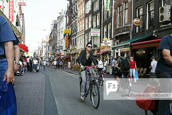 Damstraat  busy street with many restaurant hotels and shops  Amsterdam  Holland.