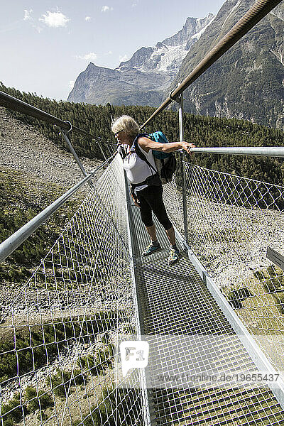 Hiker on Charles Kuonen Suspension Bridge  Valais  Switzerland