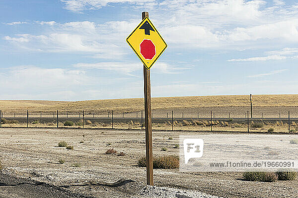Stop Sign ahead  a yellow sign and red circle with arrow  roadside safety sign.