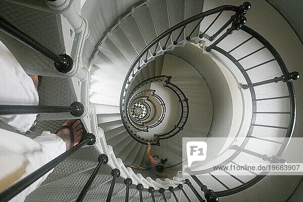 First person view of the spiral staircase of a light house.