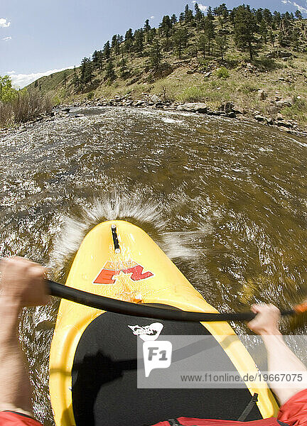 A man kayaking on the Cache La Poudre River  Fort Collins  Colorado.