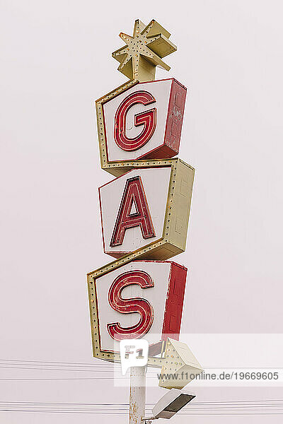 A retro style GAS station sign  red lettering road sign.