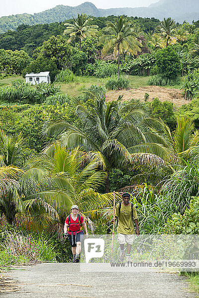 A woman and her guide hike Segment 3 of the Waitukubuli National Trail on the Caribbean island of Dominica.