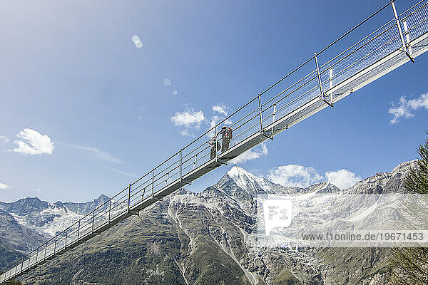 Hikers on Charles Kuonen Suspension Bridge  Valais  Switzerland