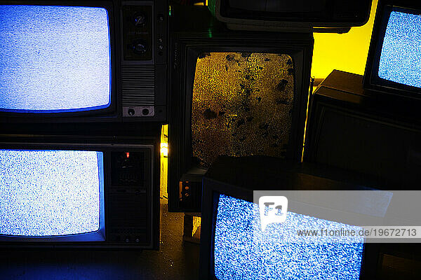Old televisions showing static.