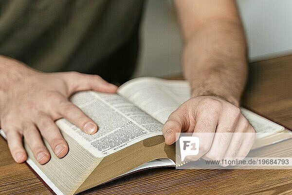 Mann liest aus der Bibeltafel