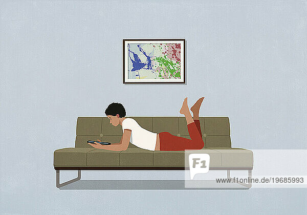 Woman relaxing  using digital tablet on living room sofa at home