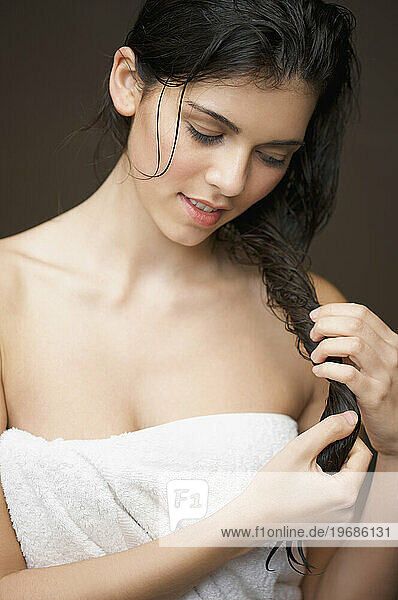 Woman touching her long wet hair