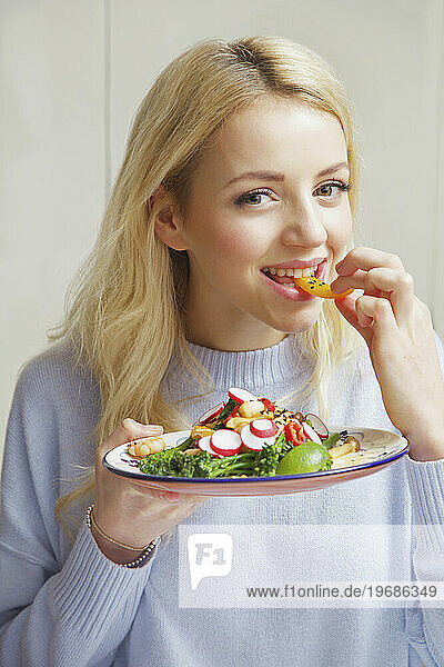 Woman Eating Stir Fry Vegetables