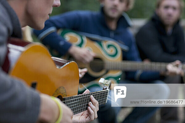 Men Playing Acoustic Guitars