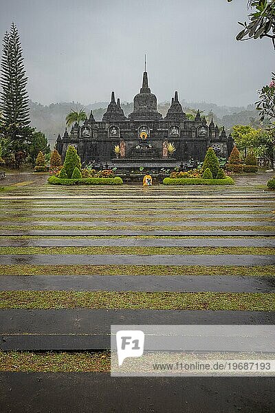 A Buddhist temple in the evening in the rain. The Brahmavihara Arama Temple has beautiful gardens and is also home to a monastery. Tropical plants near Banjar,  Bali