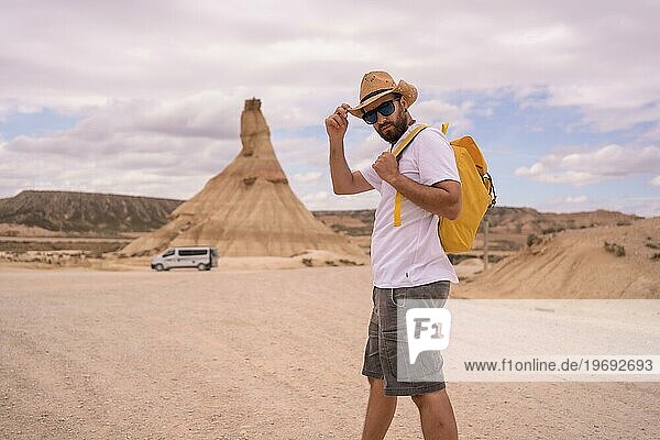 Horizontal photo with copy space of an explorer in an arid national park looking at camera