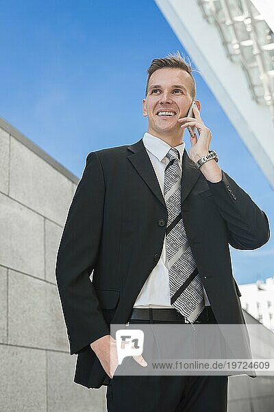 Glücklicher Geschäftsmann beim Telefonieren