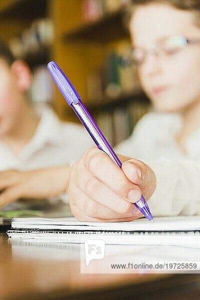Crop child s hand writing school copybook
