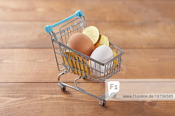 Shopping cart with eggs and coins