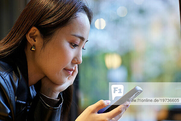 Young Japanese woman with smartphone