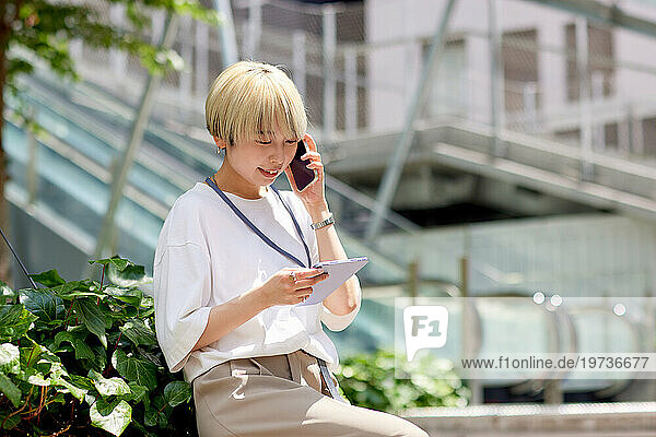 Young Japanese woman talking on the phone downtown Tokyo
