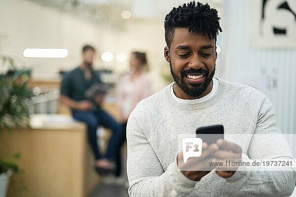 African American man texting on smart phone