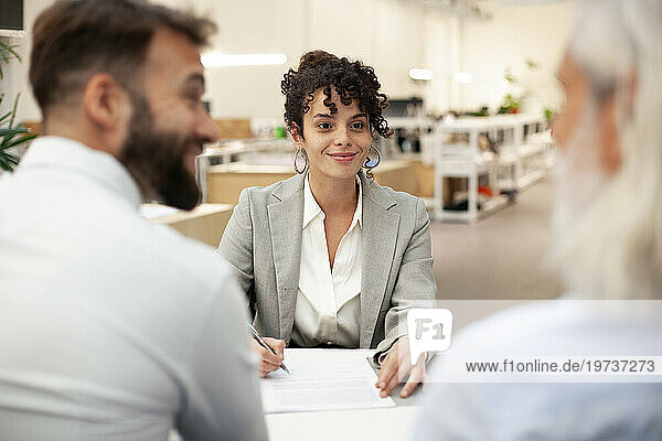 Female bank worker having a meeting with two clients