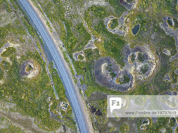 Aerial vertical view of old volcano and asphalt road  near to Myvatn lake on a summer day  Iceland  Polar Regions