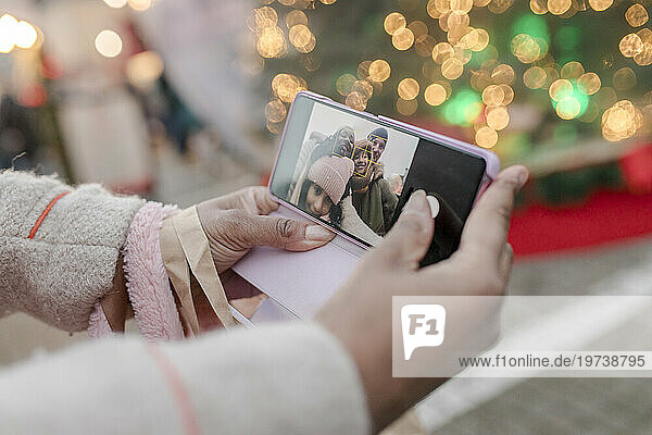 Woman taking selfie with family through smart phone