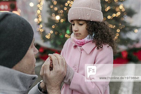 Father consoling daughter at Christmas market