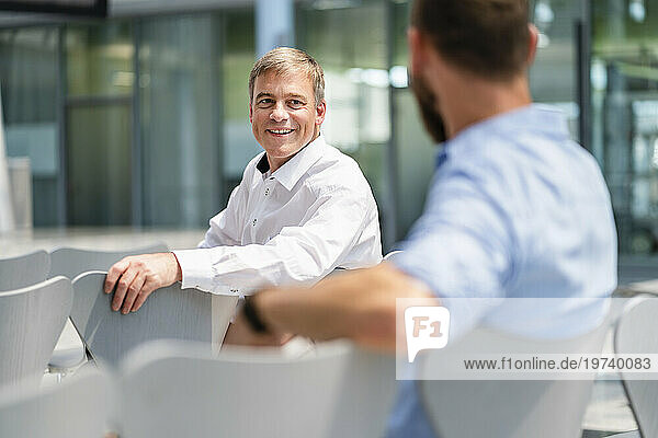 Confident businessman meeting colleague in company auditory