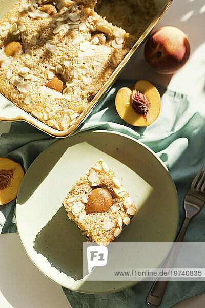 Slice of peach pie with almonds