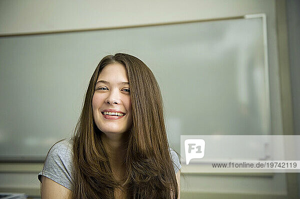 Portrait of a beautiful young woman in a classroom; Fairbanks  Alaska  United States of America