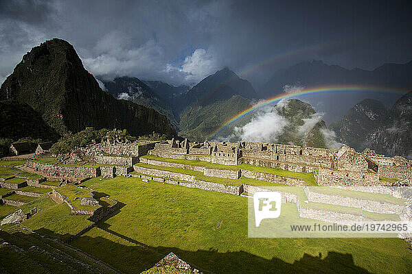 Rainbows form above the ruins of Machu Picchu; Peru