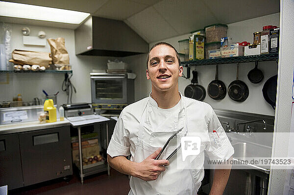 Young chef in a restaurant kitchen; Chicago  Illinois  United States of America