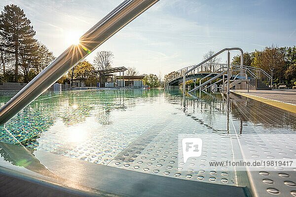 Schwarm von Sonnenstrahlen über einem ruhigen Schwimmbad hinter Edelstahlgeländern  Freibad Calw  Stammheim der Stadtwerke Calw  Schwarzwald  Deutschland  Europa