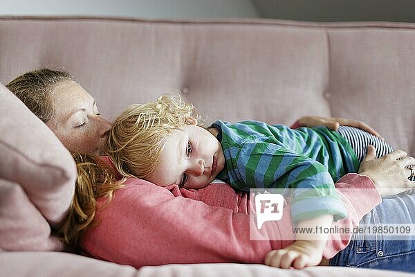 Topic: Mother and child cuddling on a sofa