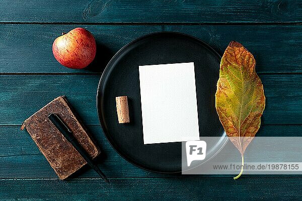 Herbst Briefpapier Mockup  eine vertikale A5 Grußkarte oder Einladung  Schuss von oben auf einem Tablett mit einem Weinkorken und einem Herbstblatt  auf einem dunklen hölzernen Hintergrund