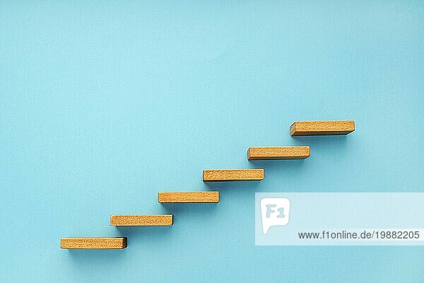 Holztreppe auf blauem Hintergrund. Wachstum  wachsendes Geschäft  Erfolgsprozesskonzept. Kopieren Raum