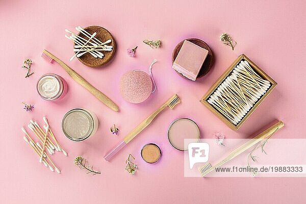 Plastikfreie  abfallfreie Kosmetika  flachgelegt auf rosa Hintergrund. Zahnbürsten und Wattestäbchen aus Bambus  Konjac Schwamm  natürliche Bio Produkte